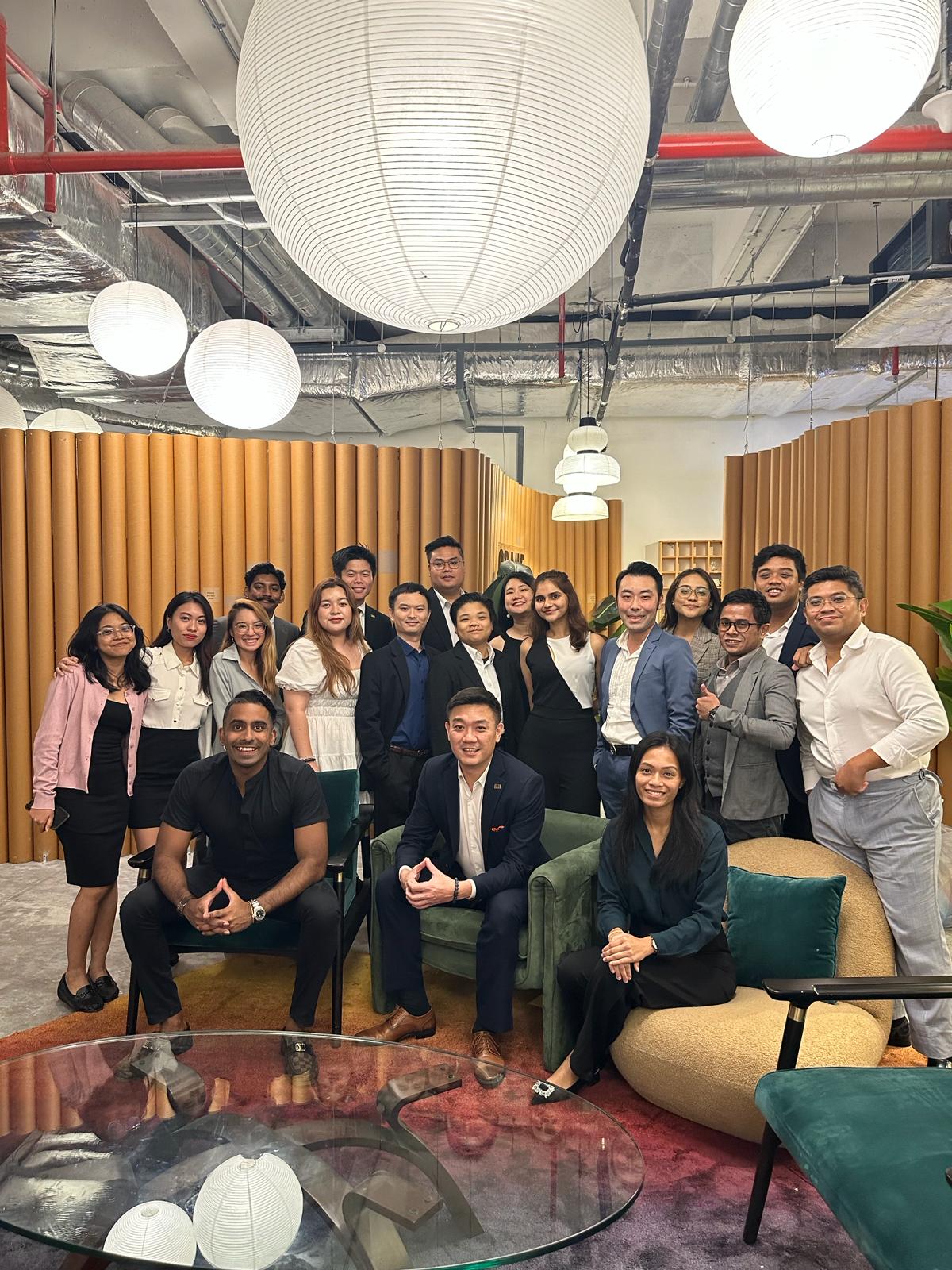DC Marketing team members relaxing together in a warmly lit office lounge